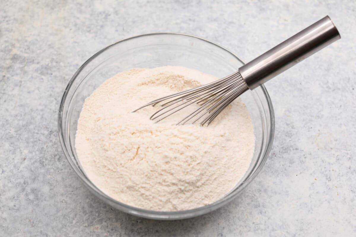 Dry ingredients whisked together in a glass bowl. 