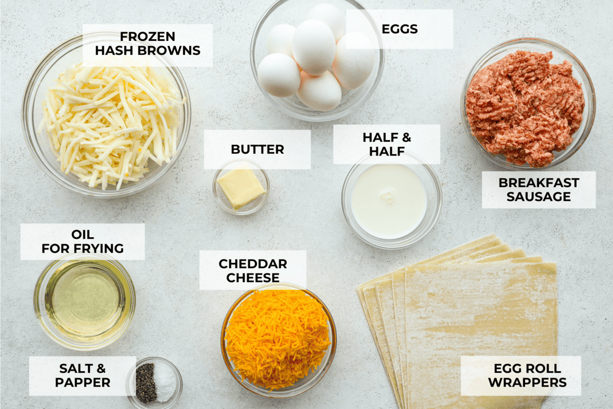 Breakfast Egg Rolls are a fun and delicious way to change up breakfast! The inside is filled with savory sausage, creamy eggs, hash browns, and plenty of cheese. Fry them up for a gooey, tender, savory center and a delicately crunchy exterior. This is a fun and unique breakfast that everyone will love! overhead shot of different ingredients with labels.