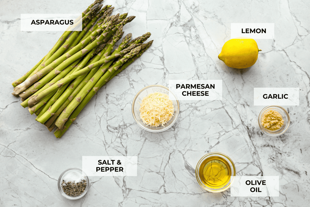 You'll love the combination of flavors in this roasted lemon parmesan garlic asparagus! It's a quick and easy side dish bursting with parmesan, garlic, and a hint of lemon to brighten it all. This is a side that you will make again and again! Ingredients labeled to make roasted lemon parmesan garlic asparagus.