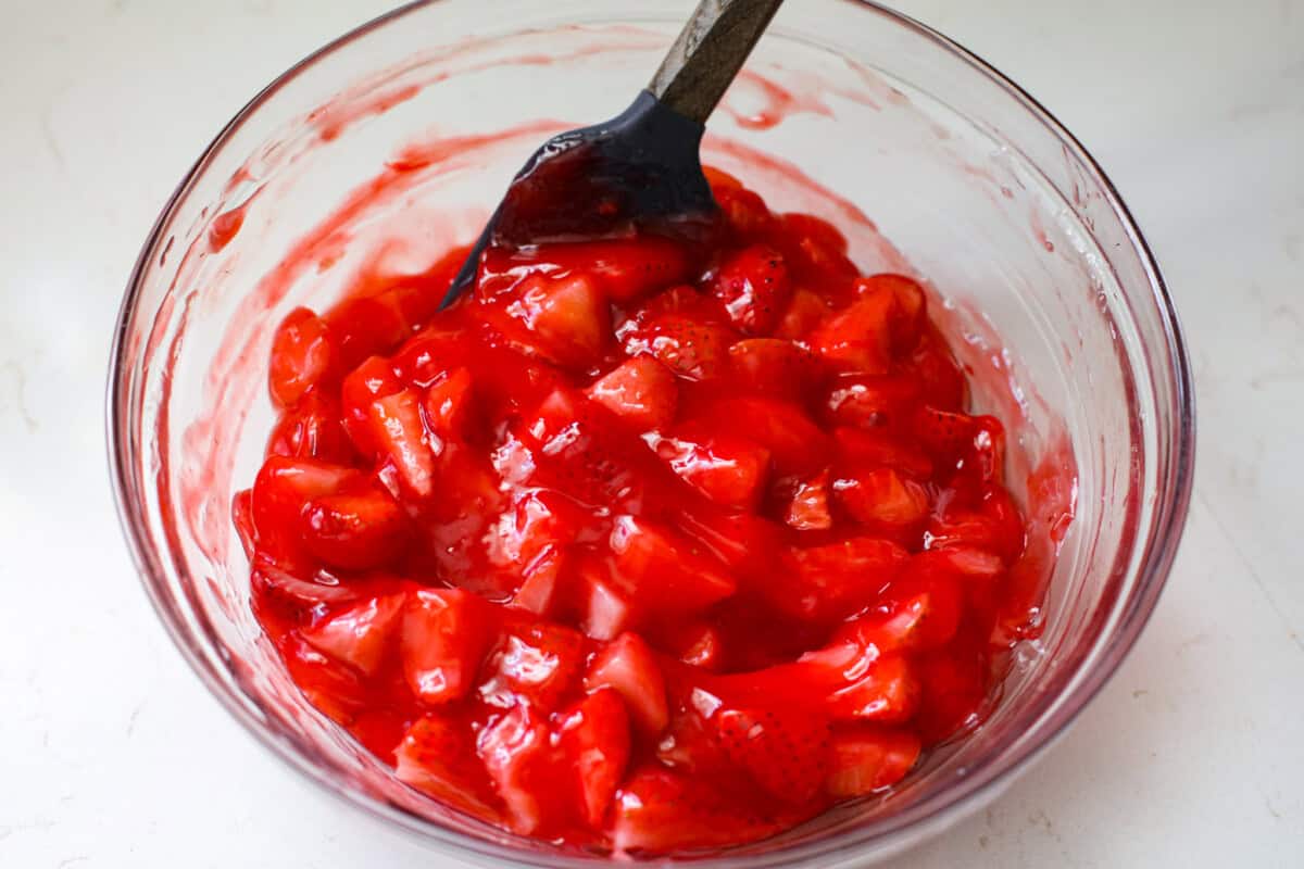 a bowl of strawberry mixture in a glass bowl. 