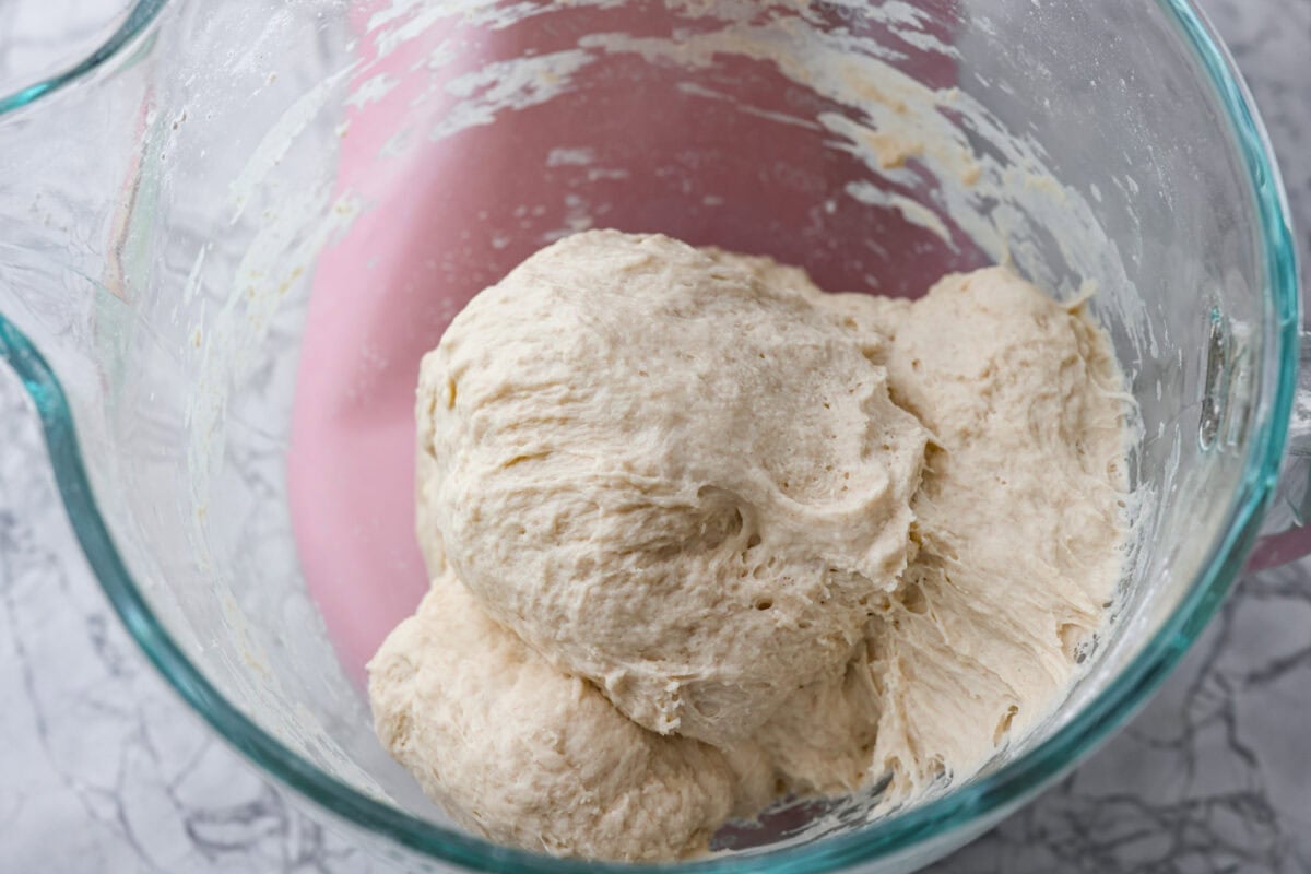 Second photo of mixed dough in a mixer.