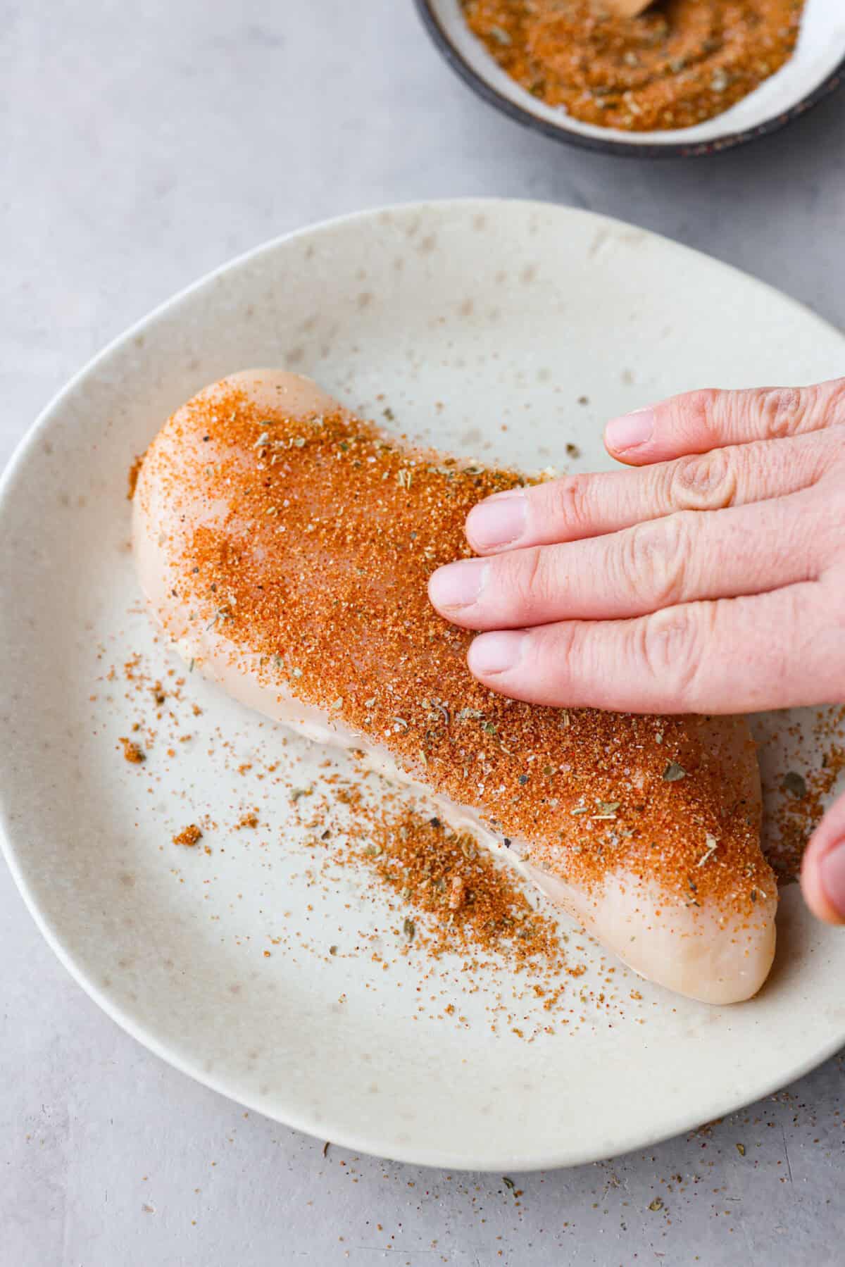 Photo of chicken seasoning rubbed on chicken.