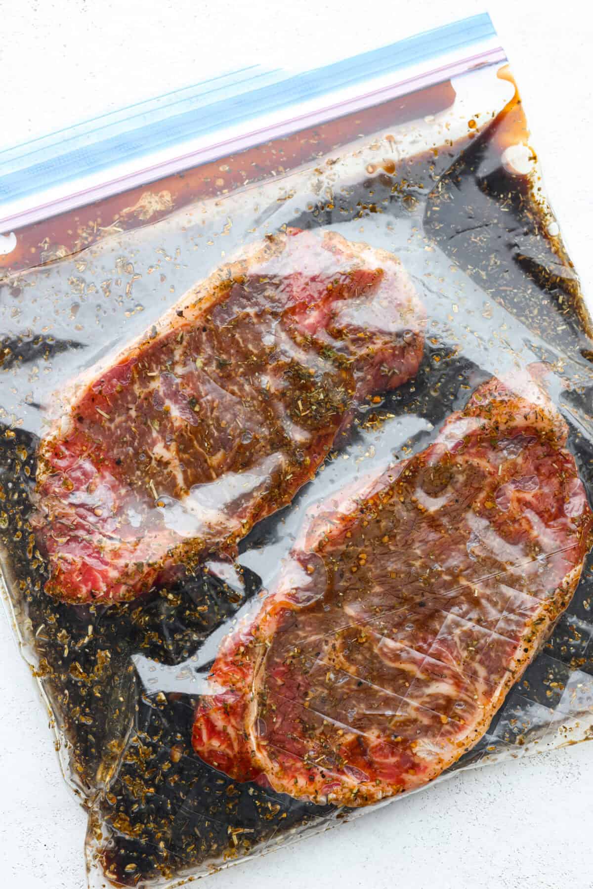 First photo of steaks marinating.