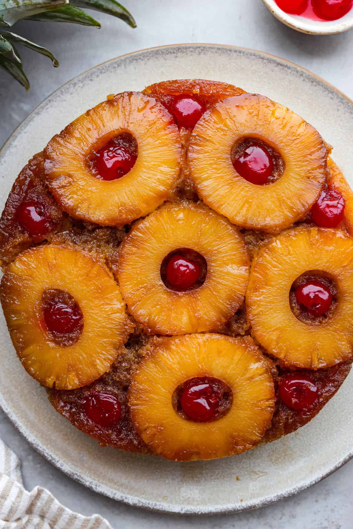 Top view of pineapple upside down cake on a plate.