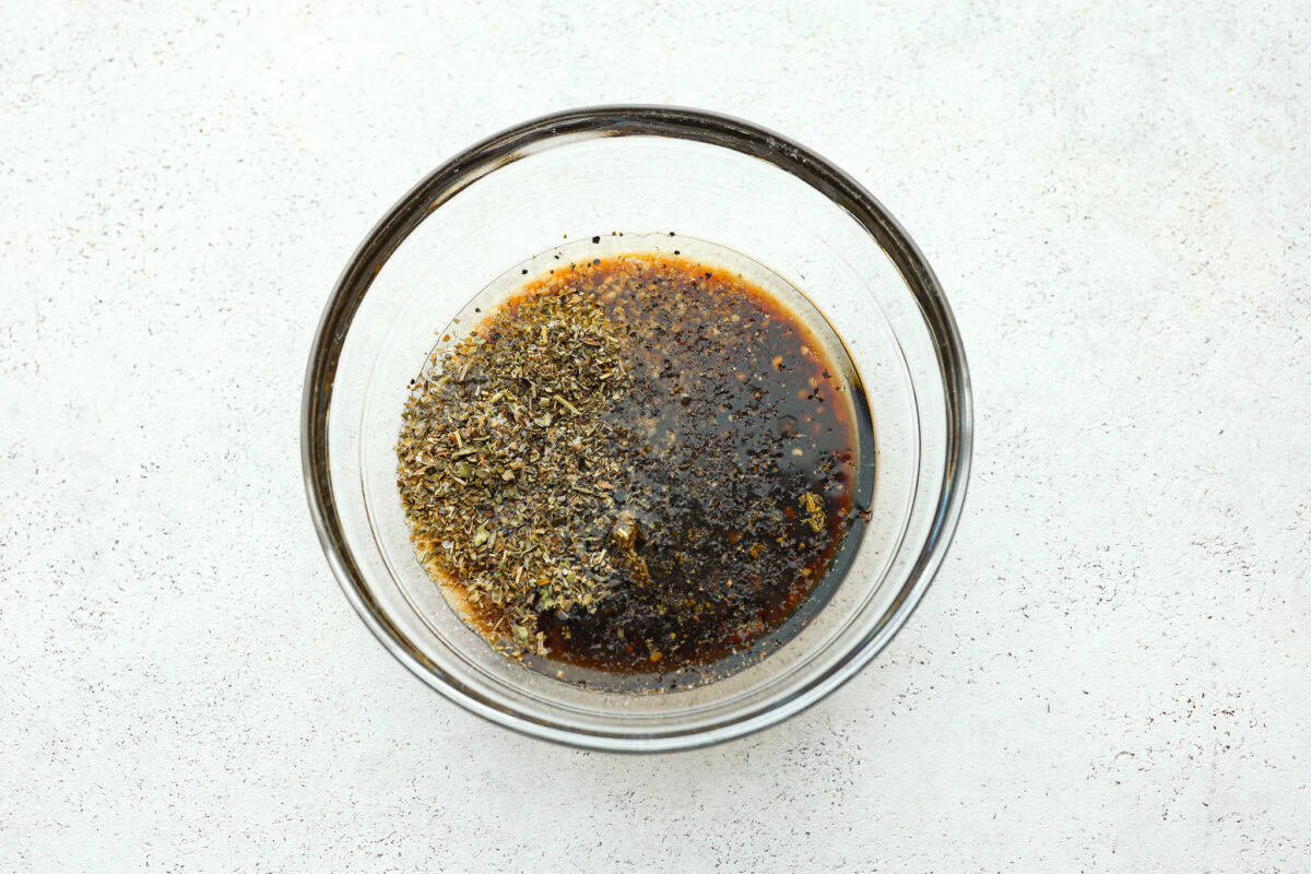 Marinade ingredients added to a glass bowl. 