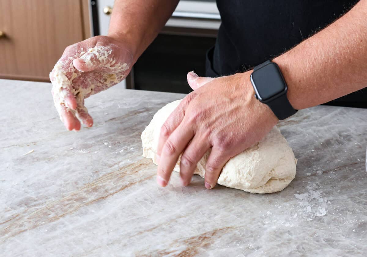 Fifth photo of shaping and kneading the dough by hand.