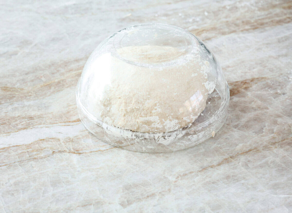 Sixth photo of a glass bowl over the dough to allow it to rest.