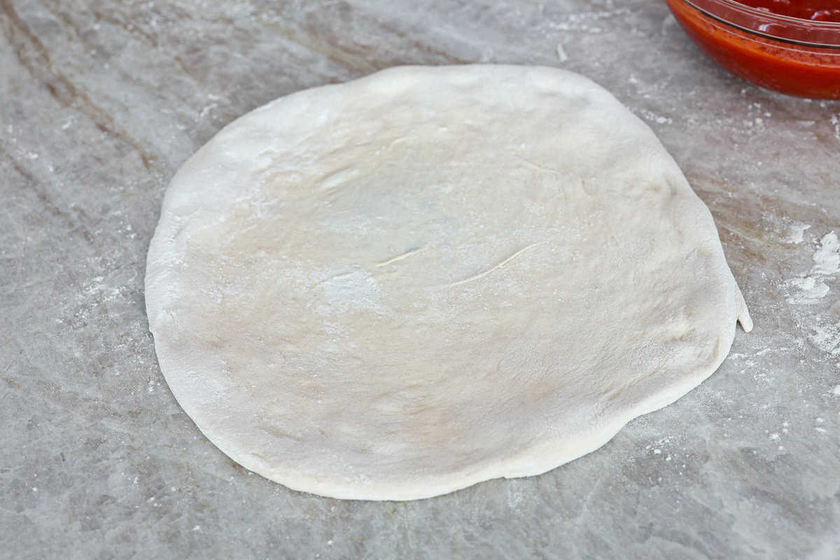 This is the perfect beginner's guide for making wood-fired pizza dough! Pizza expert, Chef Brandon Price, taught me how to make authentic homemade pizza, and now you get to learn too! Fourth photo of the finished 12