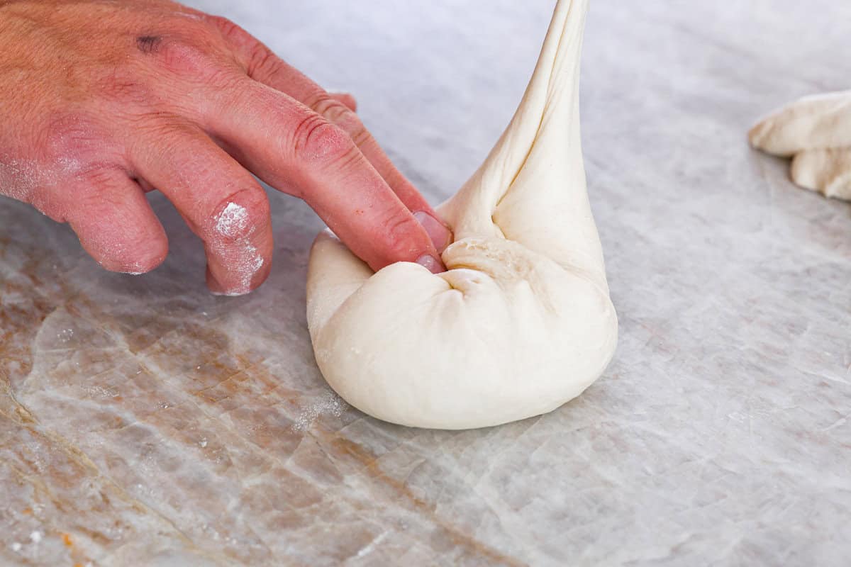 TThis is the perfect beginner's guide for making wood-fired pizza dough! Pizza expert, Chef Brandon Price, taught me how to make authentic homemade pizza, and now you get to learn too! First photo of dividing and shaping the dough into balls.