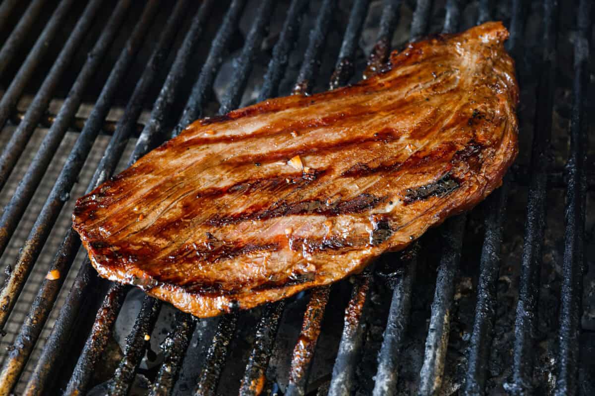 Angle shot of cooked steak on grill. 