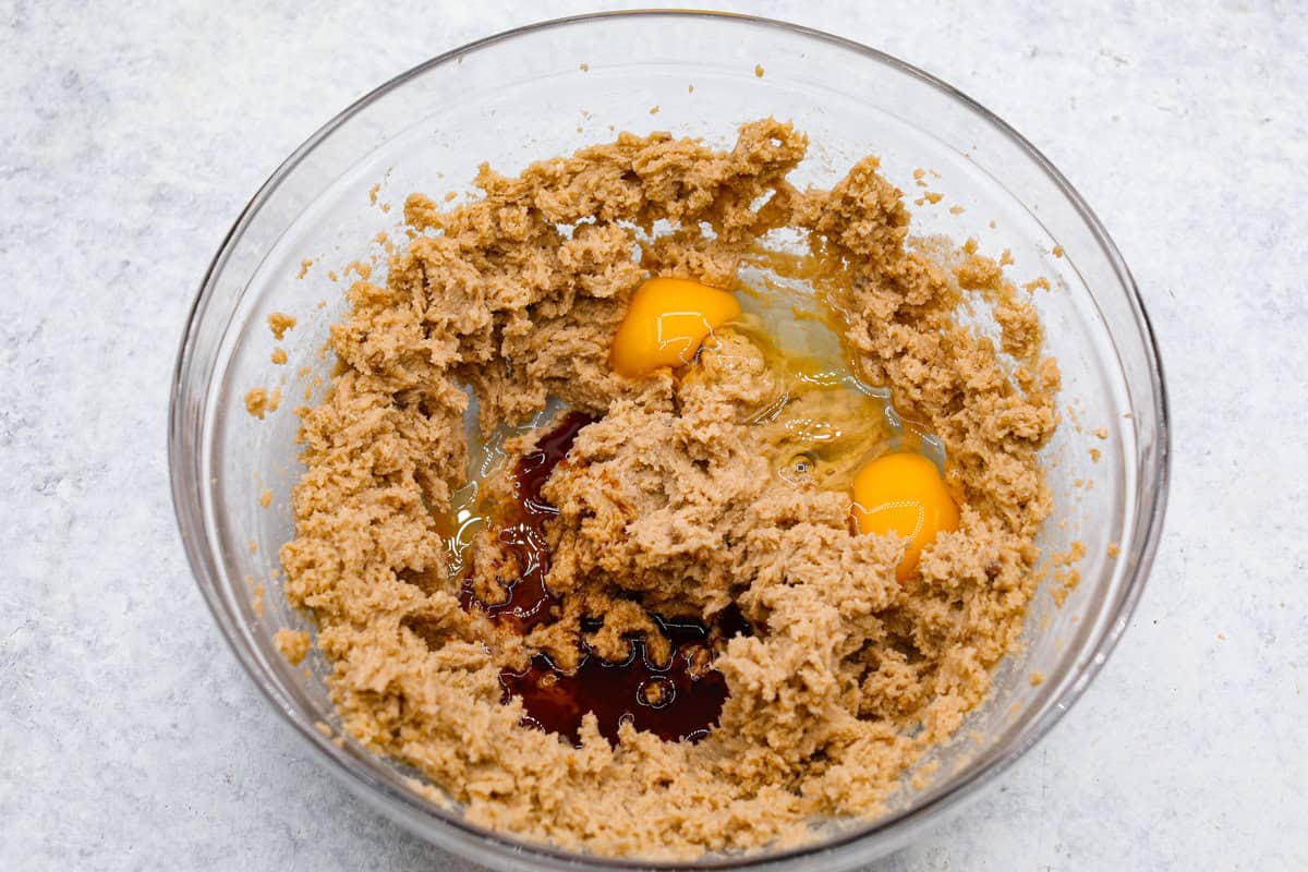Satisfy your sweet tooth with loaded Biscoff Cookies. They are soft and chewy and infused with the flavor of Biscoff cookies and cookie butter. These are easy to whip up and will be a hit for any occasion! Overhead shot of the creamed butter and sugar in a bowl with eggs and vanilla added.