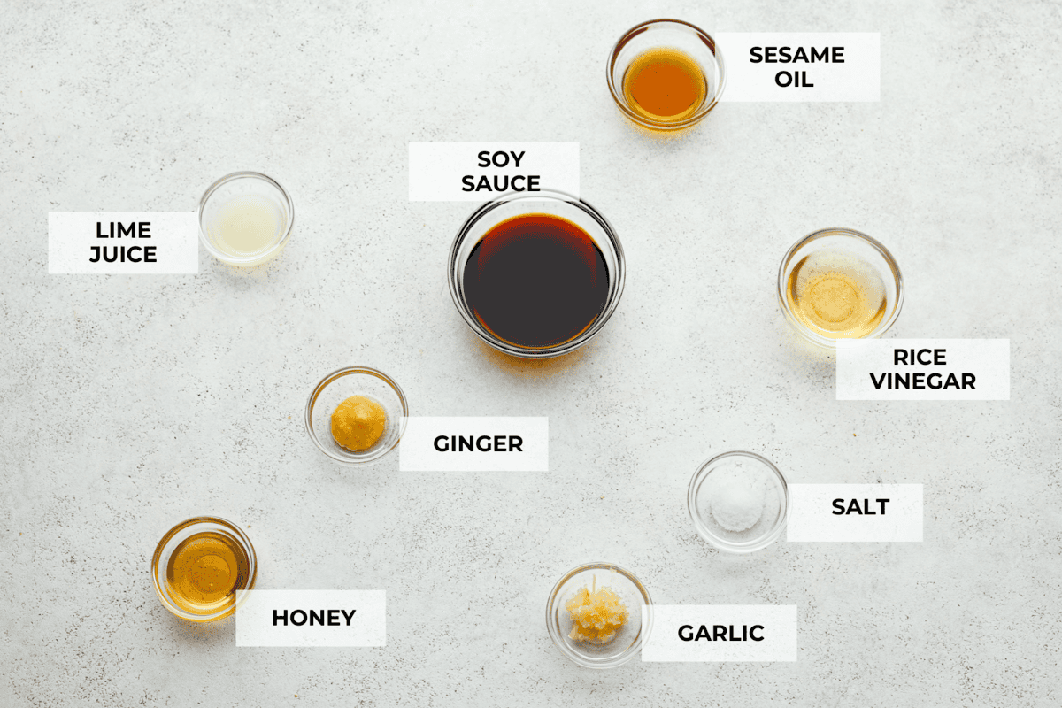The best Poke Sauce is so easy to make with just a handful of simple ingredients! Whether you are using salmon or tuna to make a poke bowl at home, this sauce is seriously delicious and will add SO much flavor to your dish. Overhead shot of individually labeled ingredients.