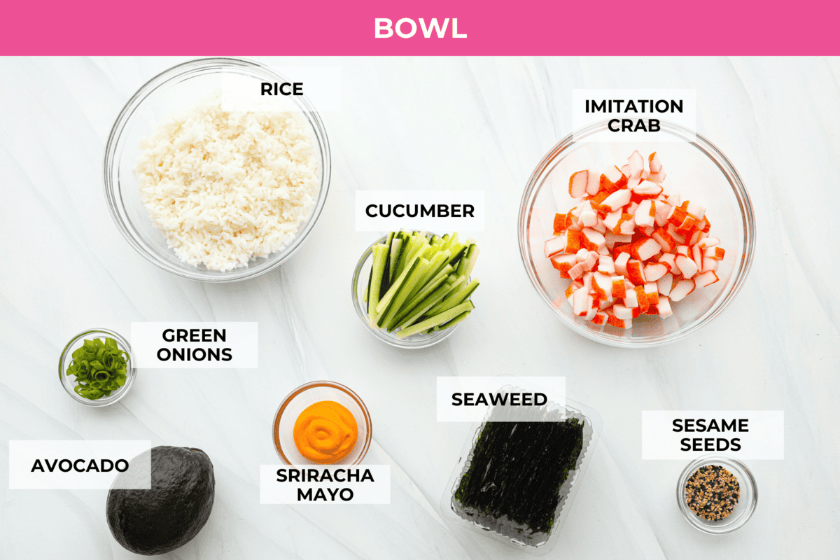 This sushi bowl is a deconstructed California sushi roll loaded with irresistible flavor and all of the best sushi ingredients. It’s layered with sushi rice, crab, cucumber, avocado, a tasty sauce, and more. It’s easy to make and ready to serve in just 20 minutes! Overhead shot of labeled ingredients.