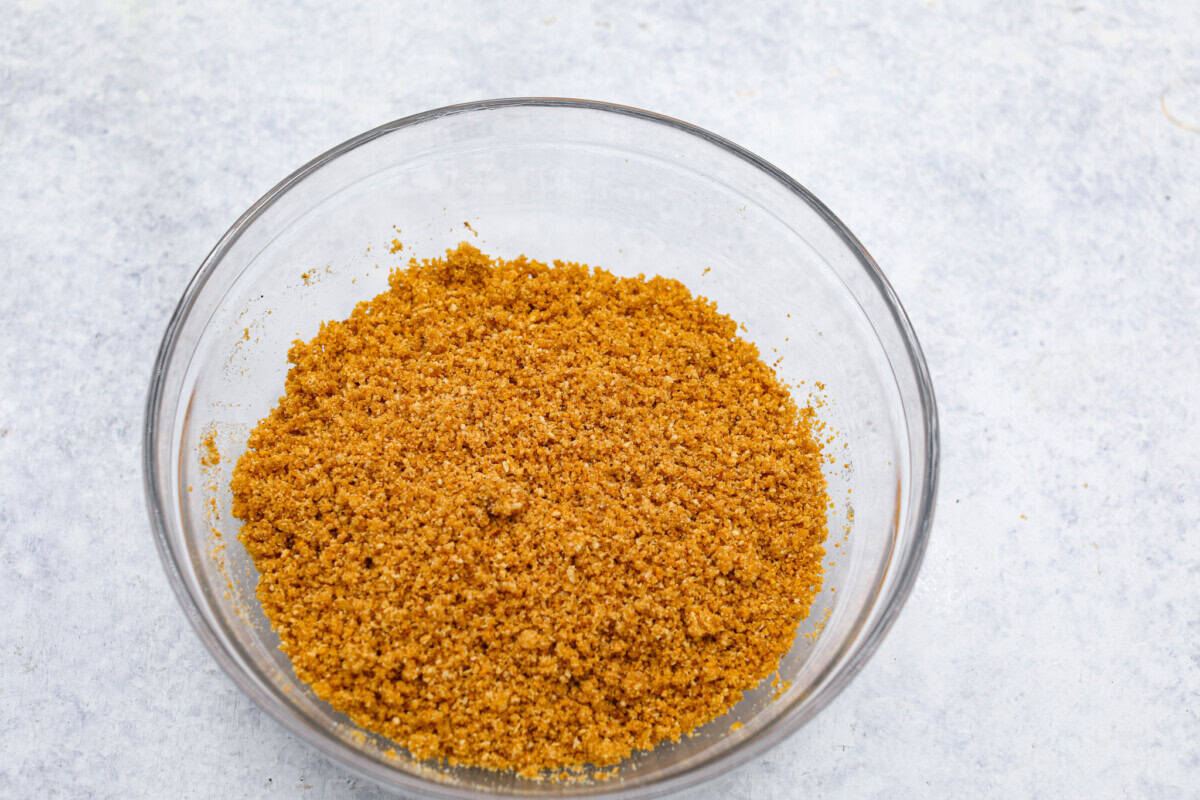 Overhead shot of graham cracker crumbs in glass bowl.