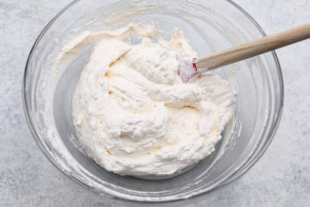 Overhead shot of whipped topping and cream cheese mixed in a bowl. 