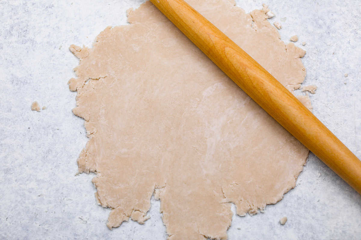 Sugar cream pie, or Hoosier pie, is a creamy, delicious treat with deep roots in the Midwest, especially in Indiana. You can top it however you like, serve it warm, at room temperature, or even chilled. Give this simple recipe a go. I know you’ll love it! Overhead shot of pie crust being rolled out on floured surface, with rolling pin.