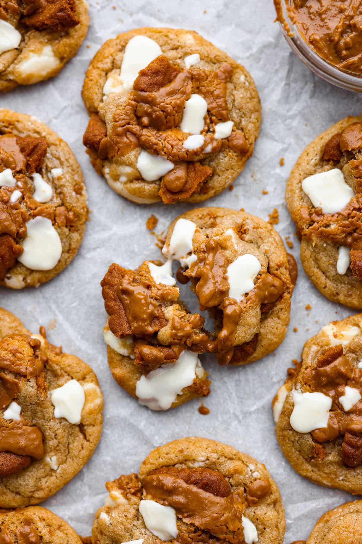 Satisfy your sweet tooth with loaded Biscoff Cookies. They are soft and chewy and infused with the flavor of Biscoff cookies and cookie butter. These are easy to whip up and will be a hit for any occasion! Close up shot of baked Biscoff cookies on a cookie sheet.