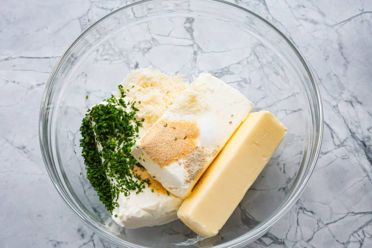 Overhead shot of ingredients dumped into a large glass bowl. 