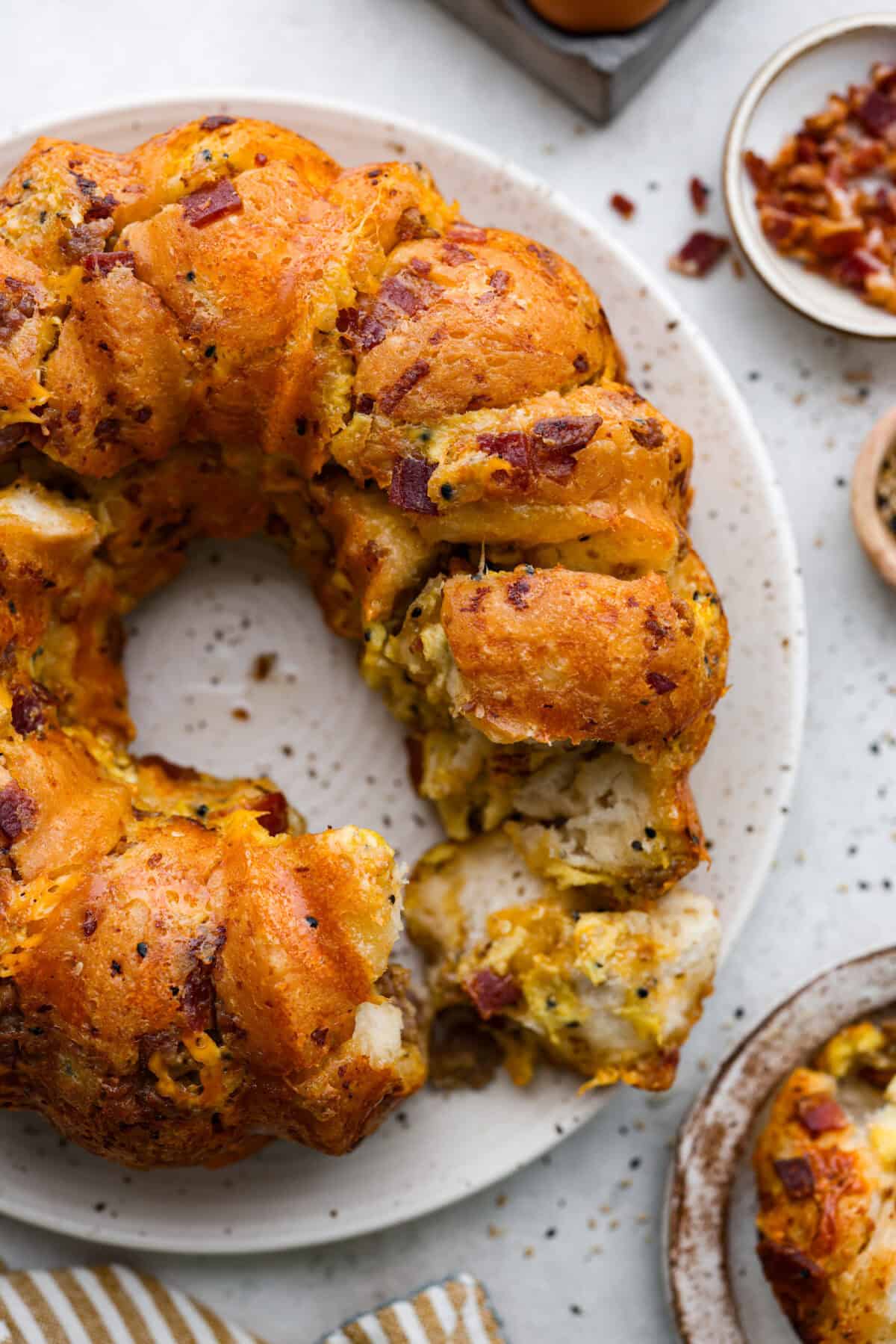 Overhead shot of savory breakfast monkey bread with piece pulled out. 