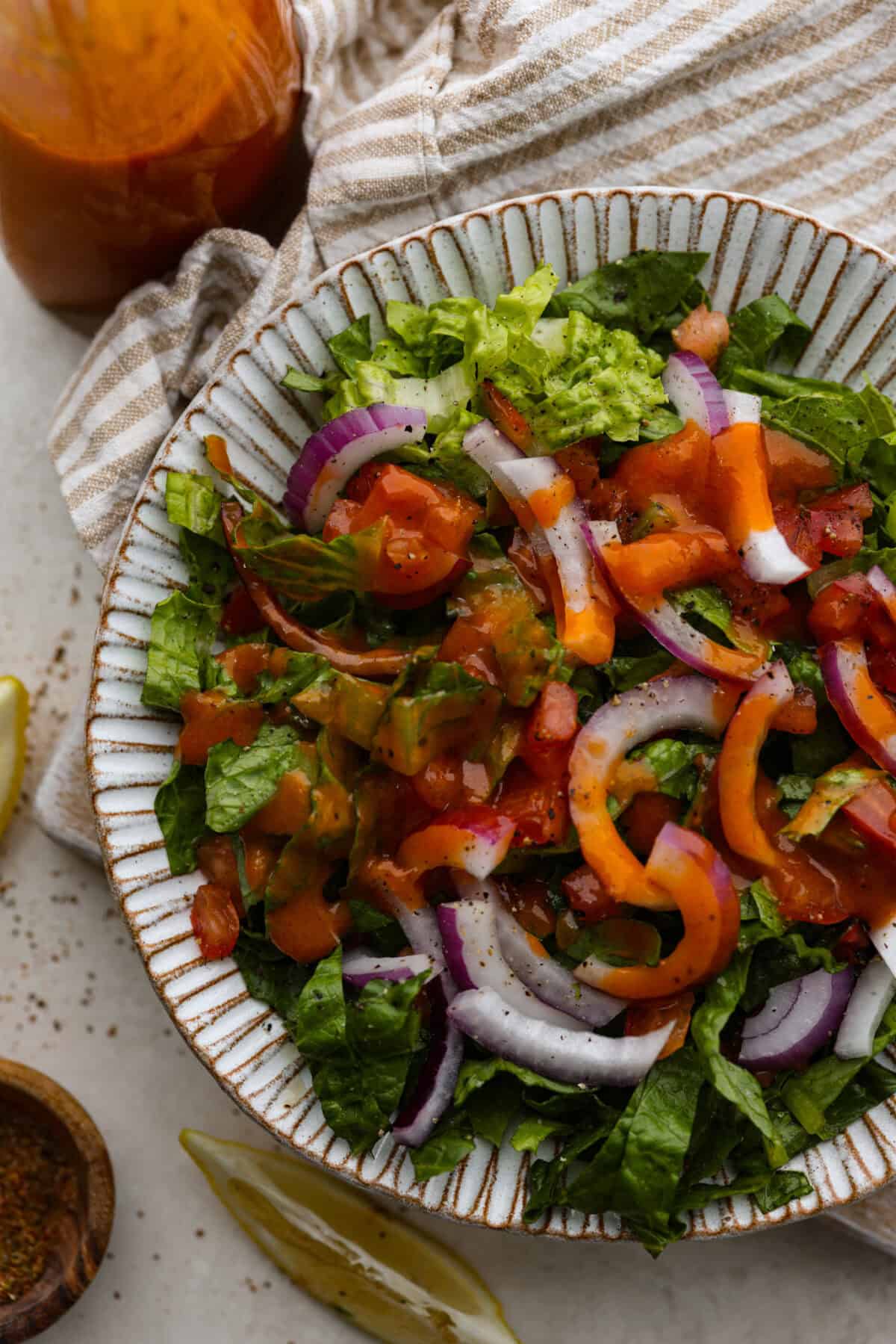 Overhead shot of plated salad with Catalina French dressing drizzled over the top. 