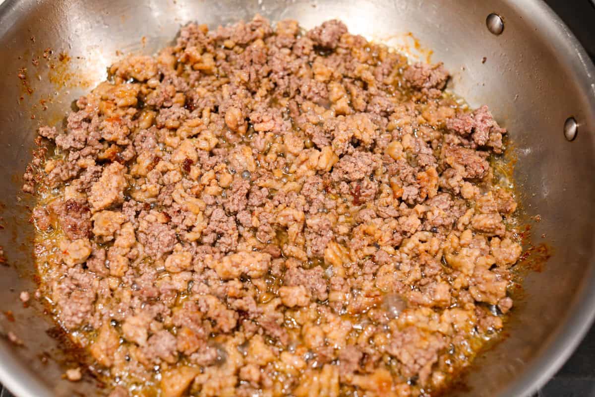 There's no need to purchase store-bought sauce, with this hearty and flavorful Homemade Spaghetti Sauce. Simple ingredients such as ground beef, onion, garlic, and spices of oregano and basil bring a bold flavor to this simple sauce. First photo of the meat browning in a pan.