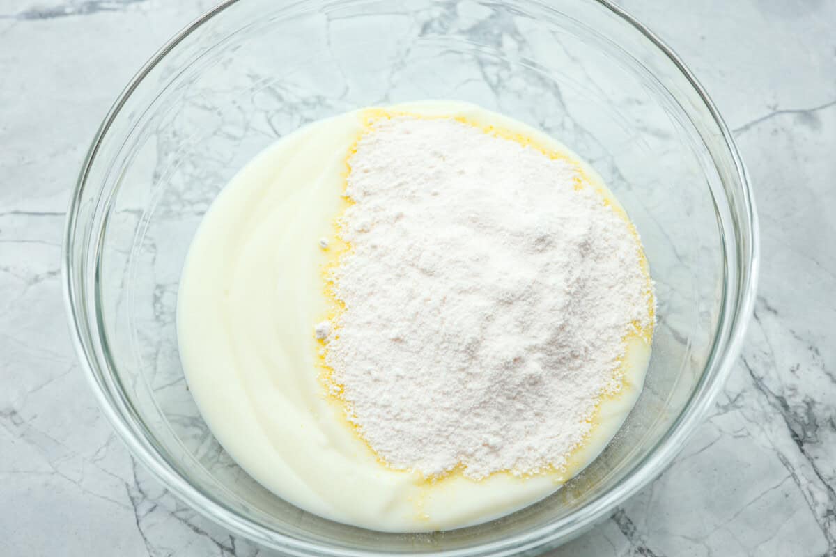Yogurt and pudding powder added to a glass bowl 