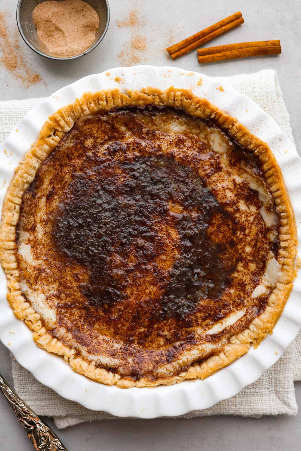 Sugar cream pie, or Hoosier pie, is a creamy, delicious treat with deep roots in the Midwest, especially in Indiana. You can top it however you like, serve it warm, at room temperature, or even chilled. Give this simple recipe a go. I know you’ll love it! Overhead shot of completed sugar cream pie.