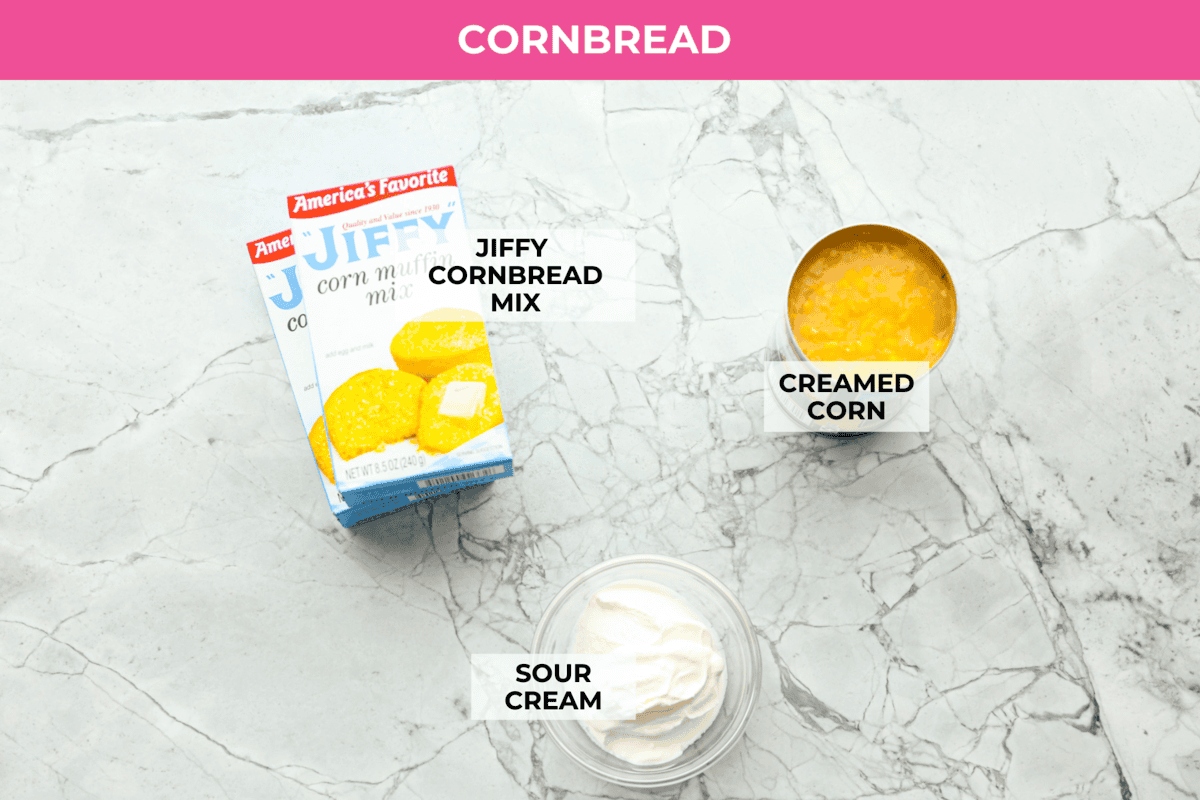Cowboy Cornbread Casserole is a flavorful, comforting meal that's so easy to make. Seasoned ground beef, corn, pinto beans, and Rotel tomatoes are layered with shredded cheddar cheese and a cornbread topping for a winning dinner! Overhead shot of labeled cornbread ingredients.