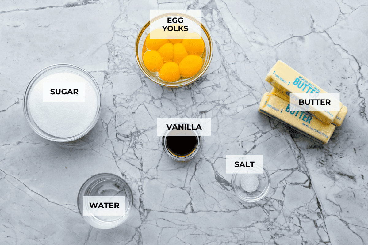 French buttercream is a luxurious, creamy frosting that will wow your guests and tantalize your taste buds. The elegant flavor comes from using egg yolks as the base and delicious, simple syrup for sweetness. Elevate your baking game with this unique recipe. Overhead shot of labeled ingredients.