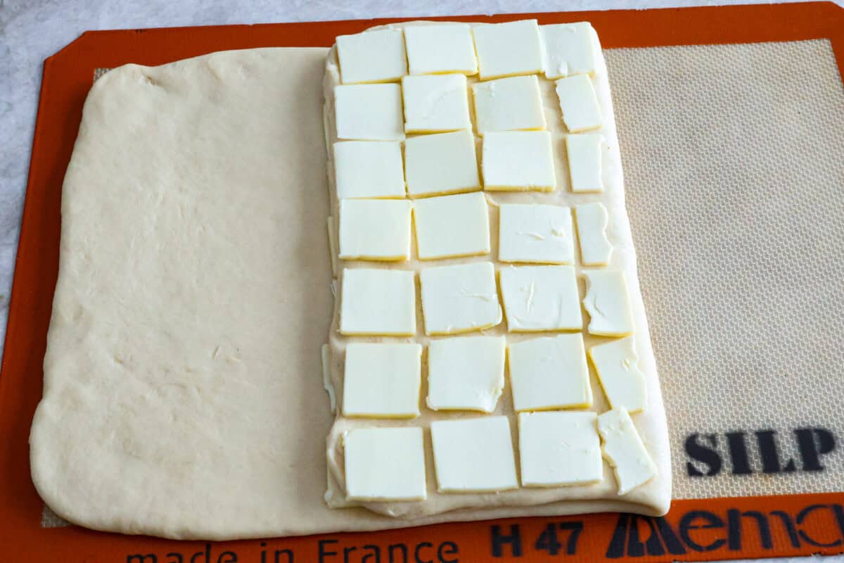 Overhead shot of butter squares laid out over the third of the 9x14 rectangle that had been folded over the middle third. 