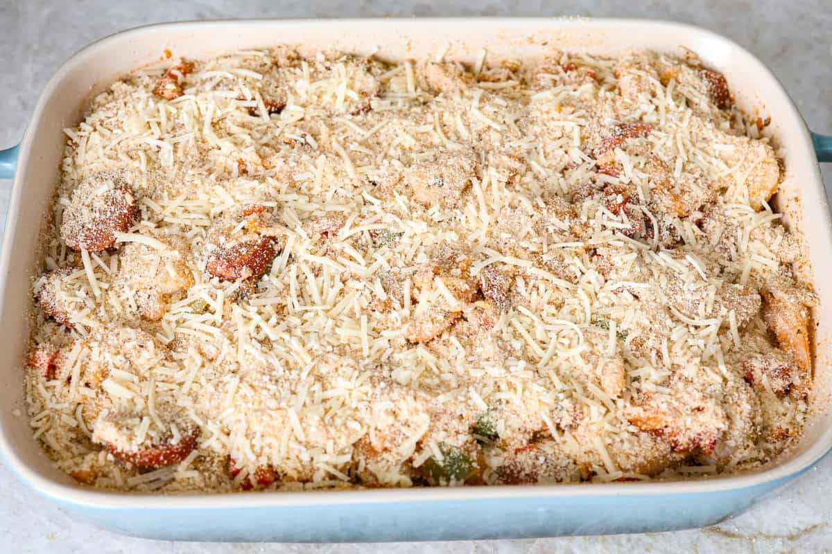 This delicious Louisiana Casserole has become an instant favorite in our house! It has all of the delicious flavors of a jambalaya in an easy-to-make casserole. Tasty andouille sausage, shrimp, veggies, rice and cajun seasoning come together for a complete meal on the table in just 40 minutes! Overhead shot of casserole ingredients in a baking dish with breadcrumb topping sprinkled over the top.