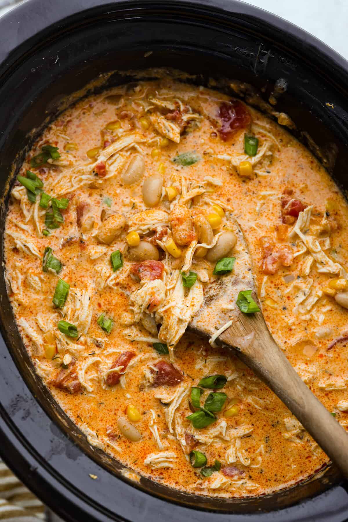 Shot over the crockpot buffalo chicken chili with a wooden spoon.