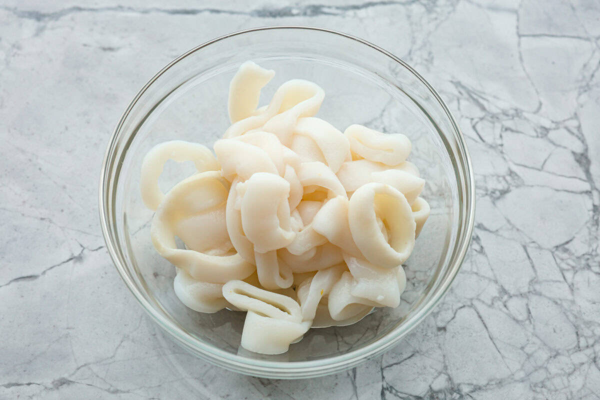 Overhead shot of calamari thawing  in a glass bowl. 