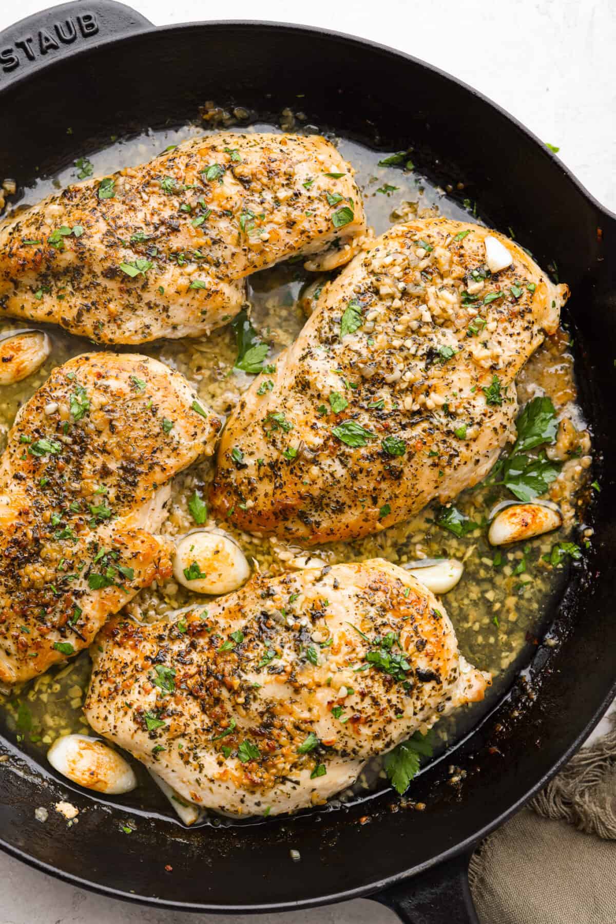 Overhead shot of seared garlic butter chicken in a skillet.