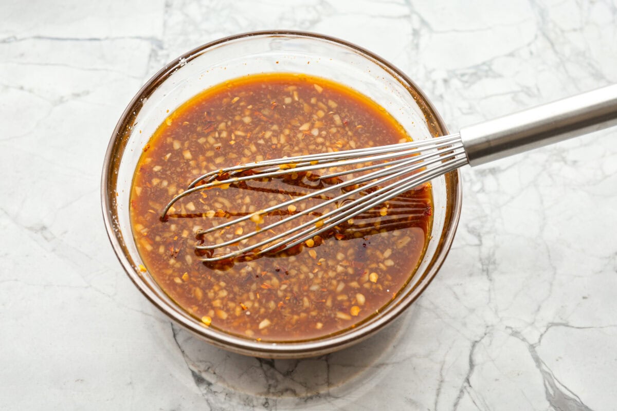 Overhead shot of sauce ingredients whisked together in a bowl. 