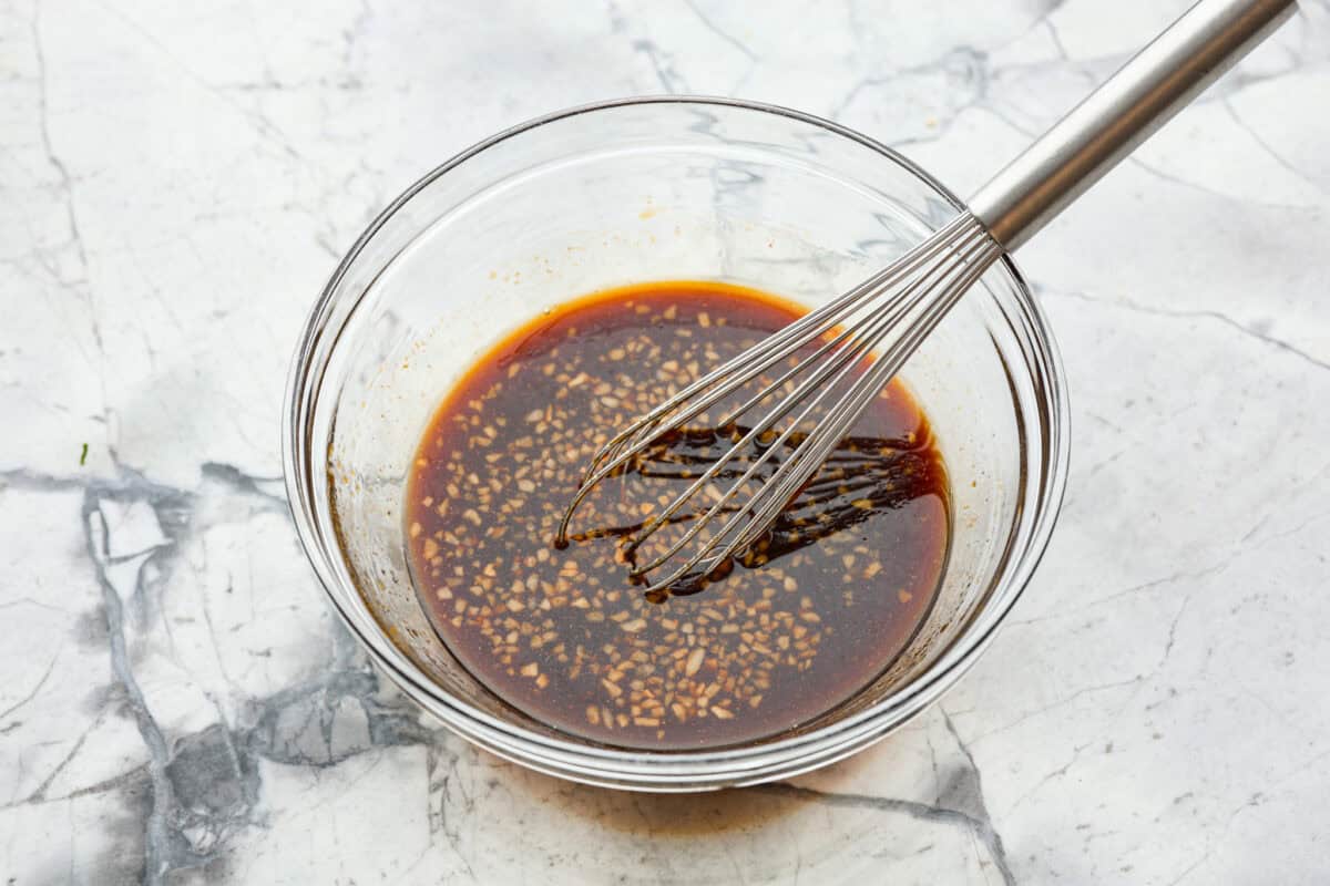 Overhead shot of marinade ingredients whisked in a bowl. 