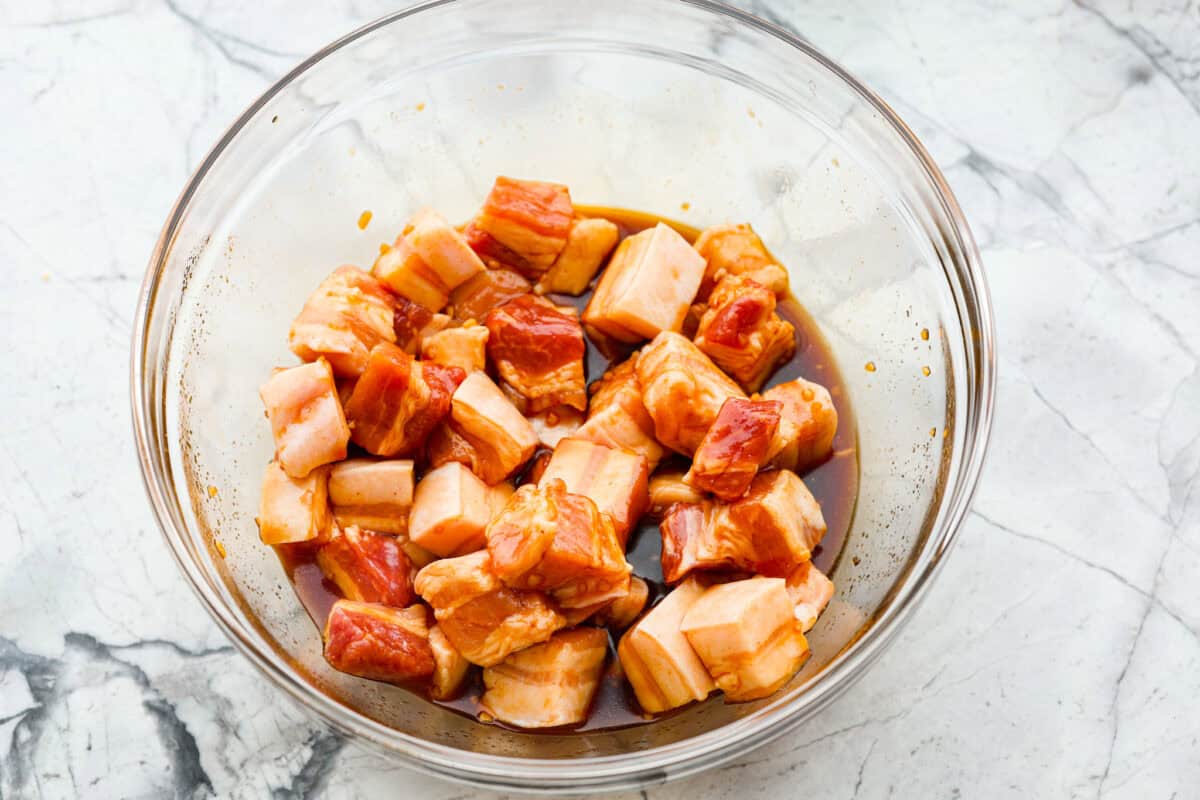 Overhead shot of meat in marinade in bowl. 