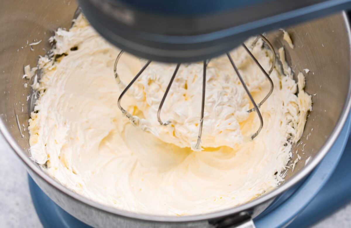 Overhead shot of the butter being whisked in a stand mixer. 