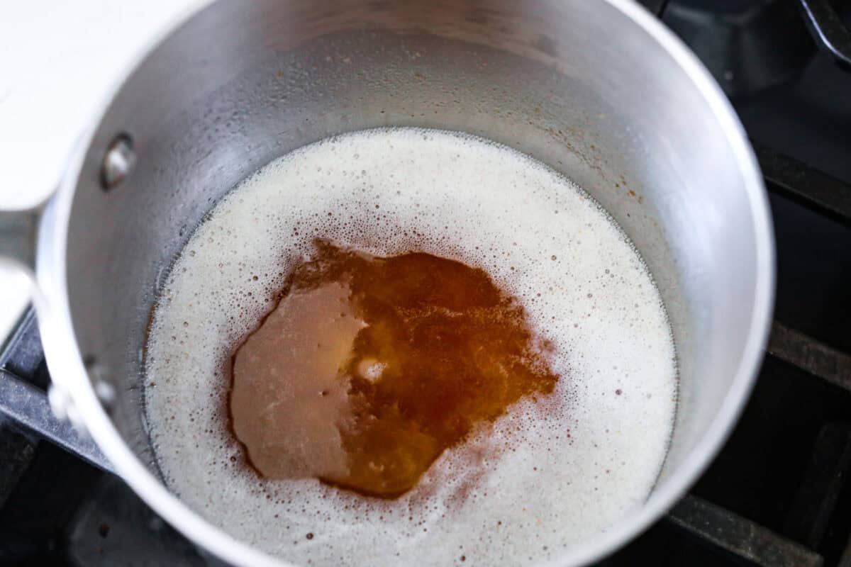 Overhead shot of butter browning in a sauce pan. 