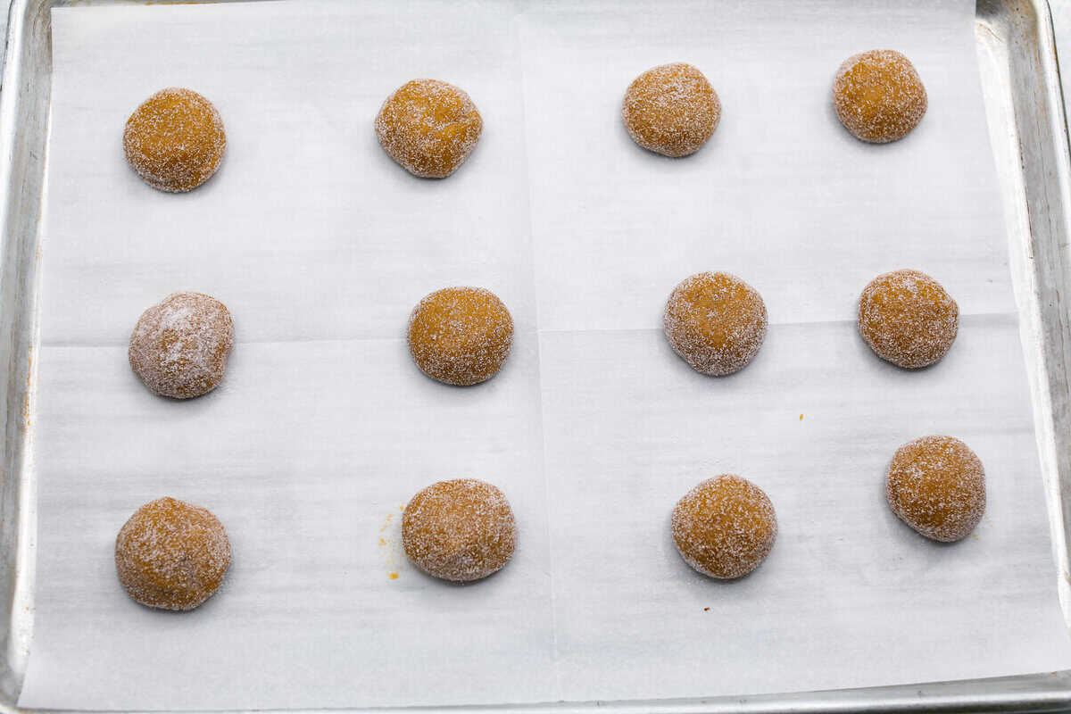 Browned Butter Sugar Cookies are irresistibly thick and chewy with rich flavor, thanks to the addition of browned butter. Even more delicious than the classic, and there's no need to chill the dough! Overhead shot of cookie dough balls spread evenly on a cookie sheet.