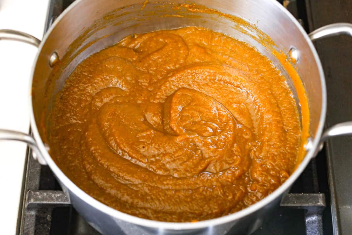 Overhead shot of puree spices and water mixture mixed together in the pan. 