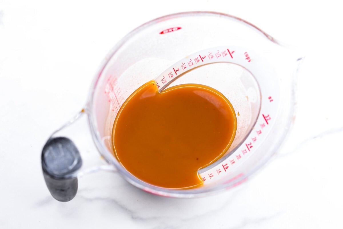 Overhead shot of strained pumpkin juice in a measuring cup. 