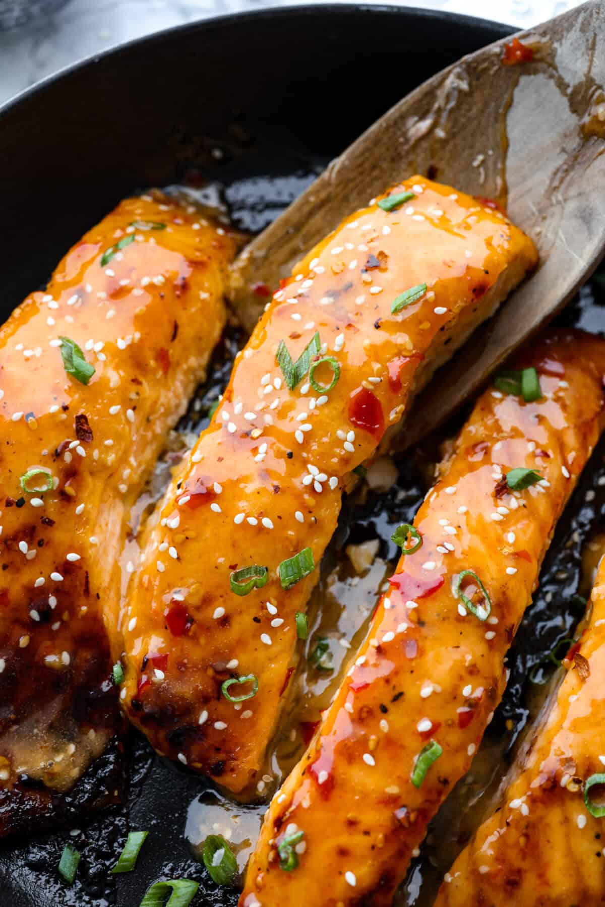 Top shot of bang bang salmon in a frying pan. 