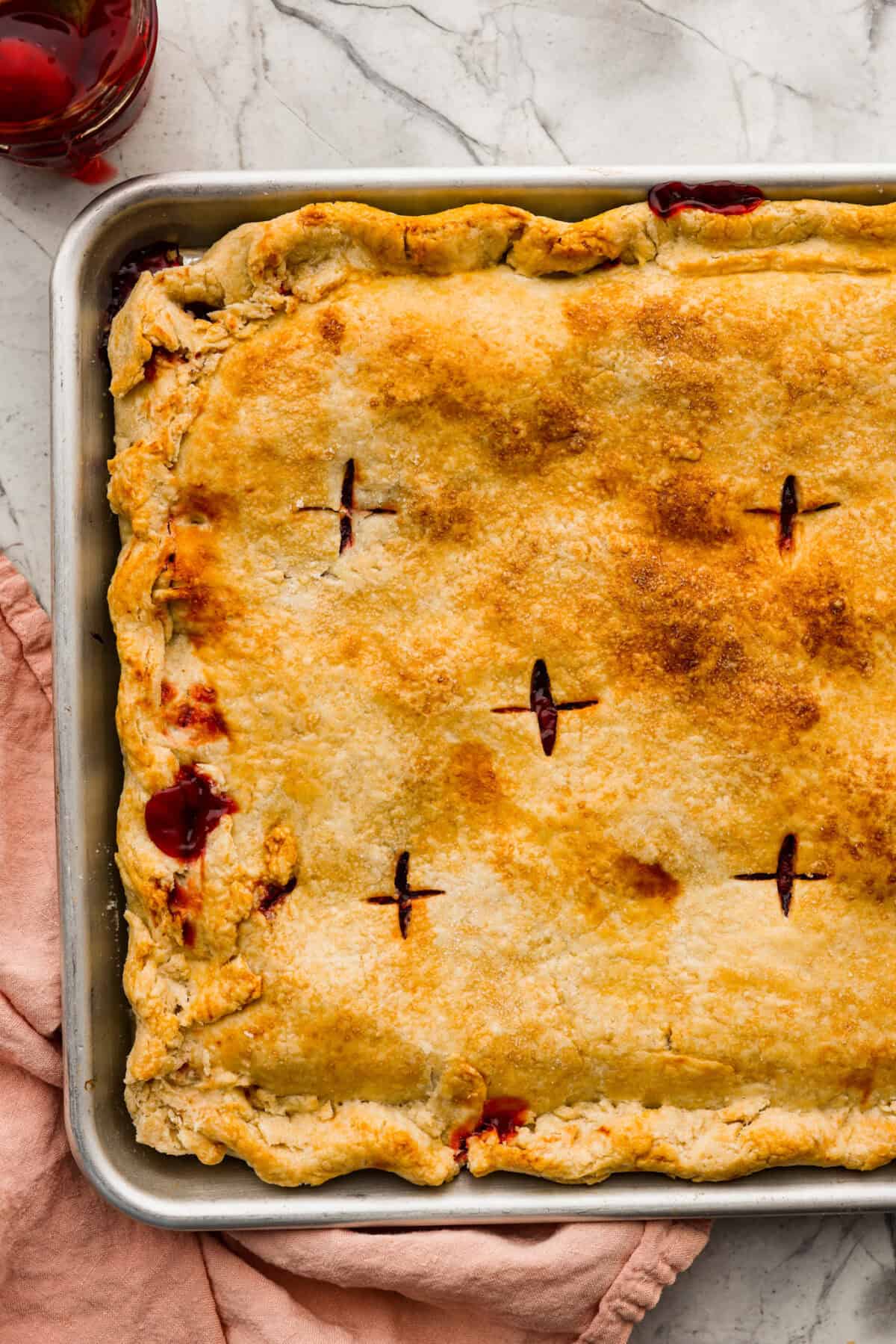 Close up shot of baked cherry pie slab just out of the oven. 