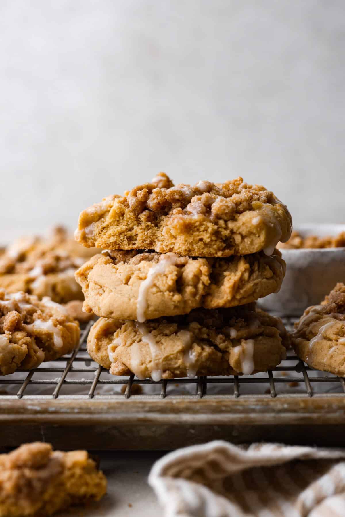 Side shot of coffee cake cookies staked on a cooling rack. 