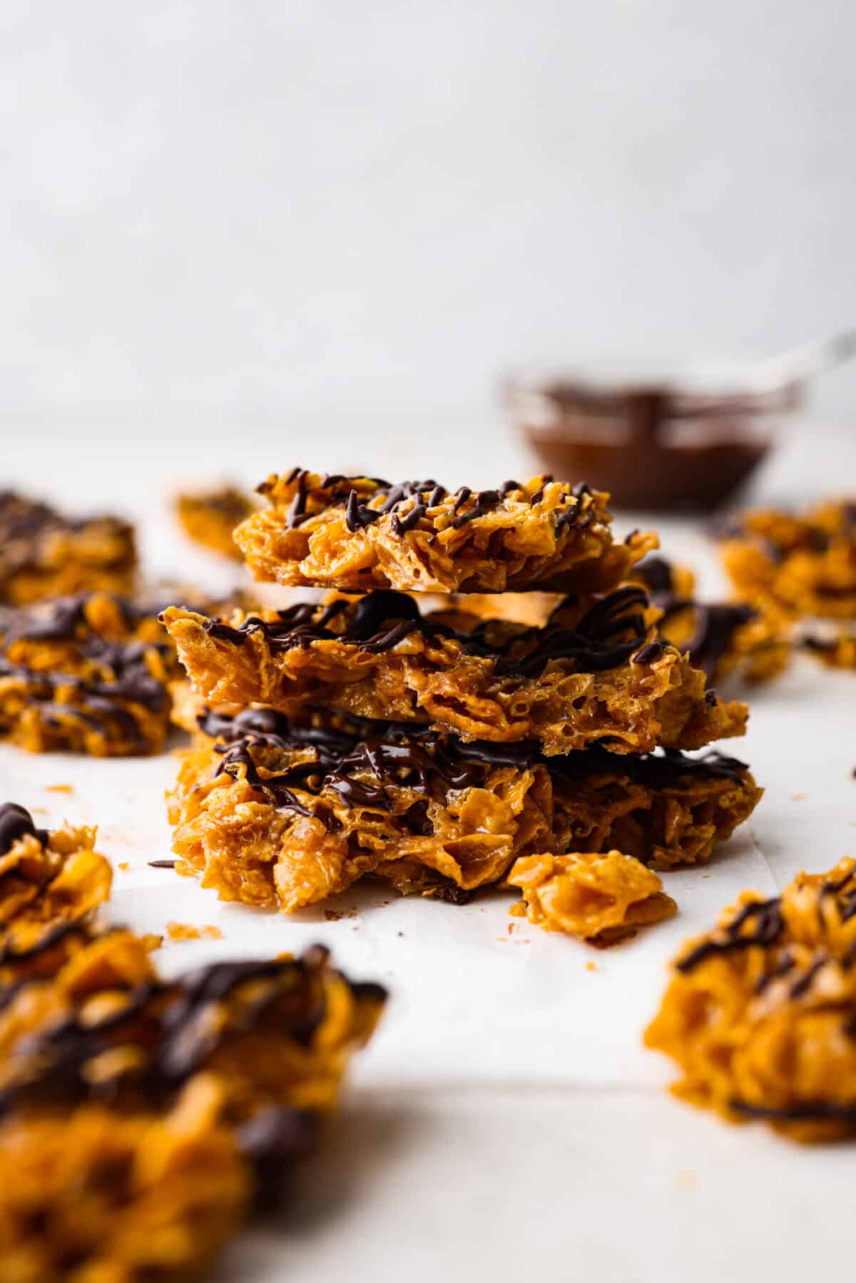 Side shot of a pile of brittle cracked corn flakes pieces. 