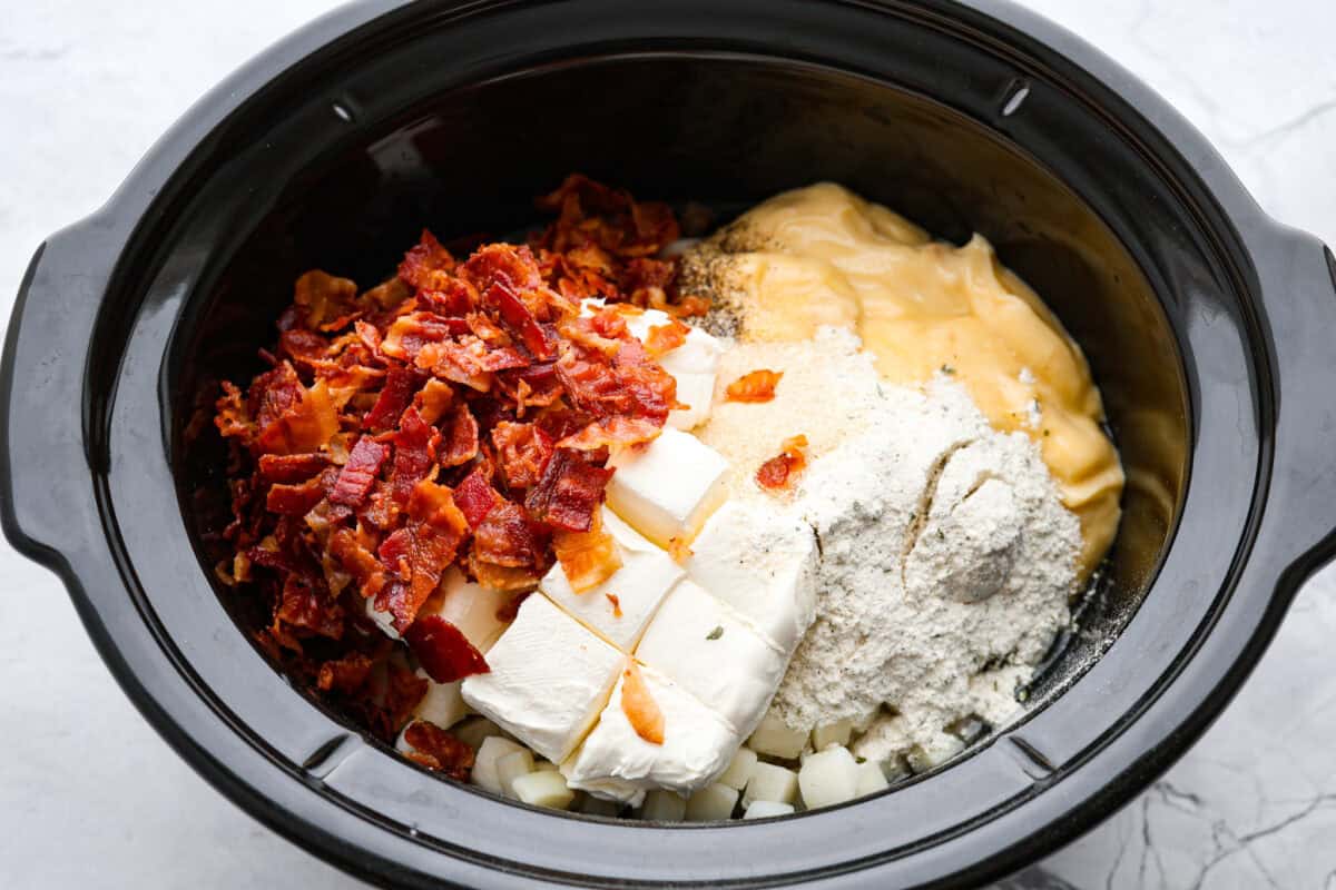 Top shot of ingredients being dumped into a crock pot. 