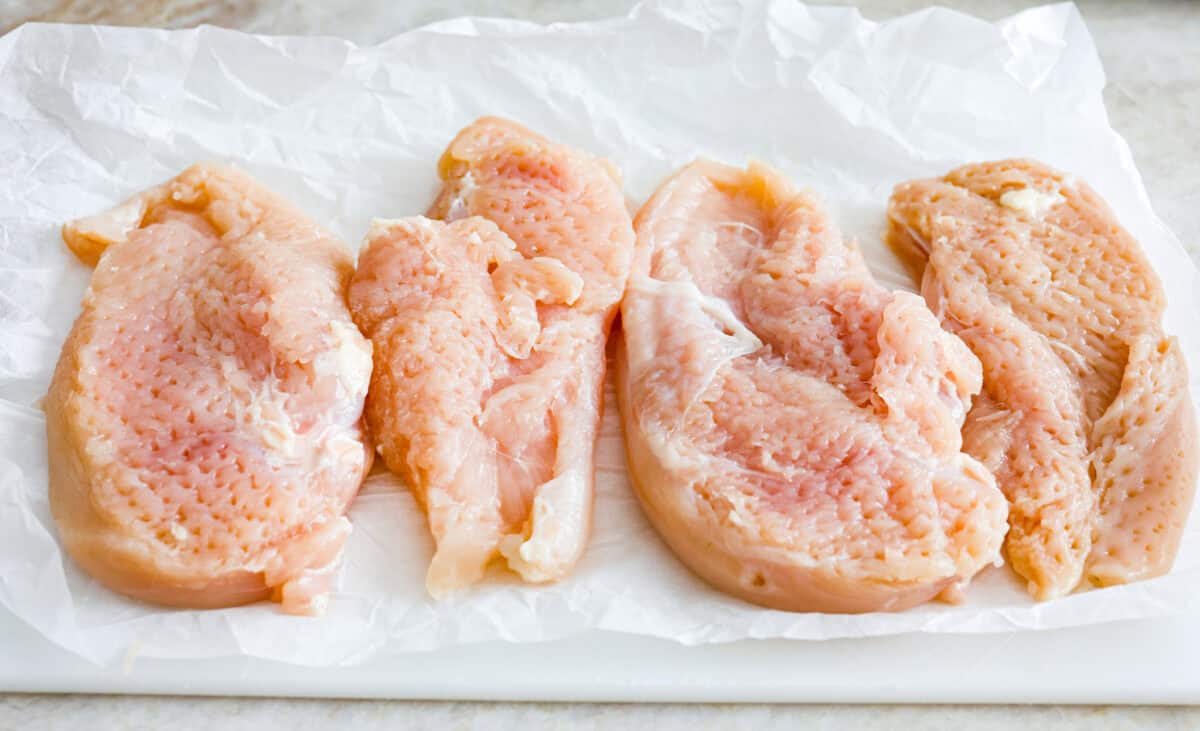 Overhead shot of chicken breasts tenderized. 