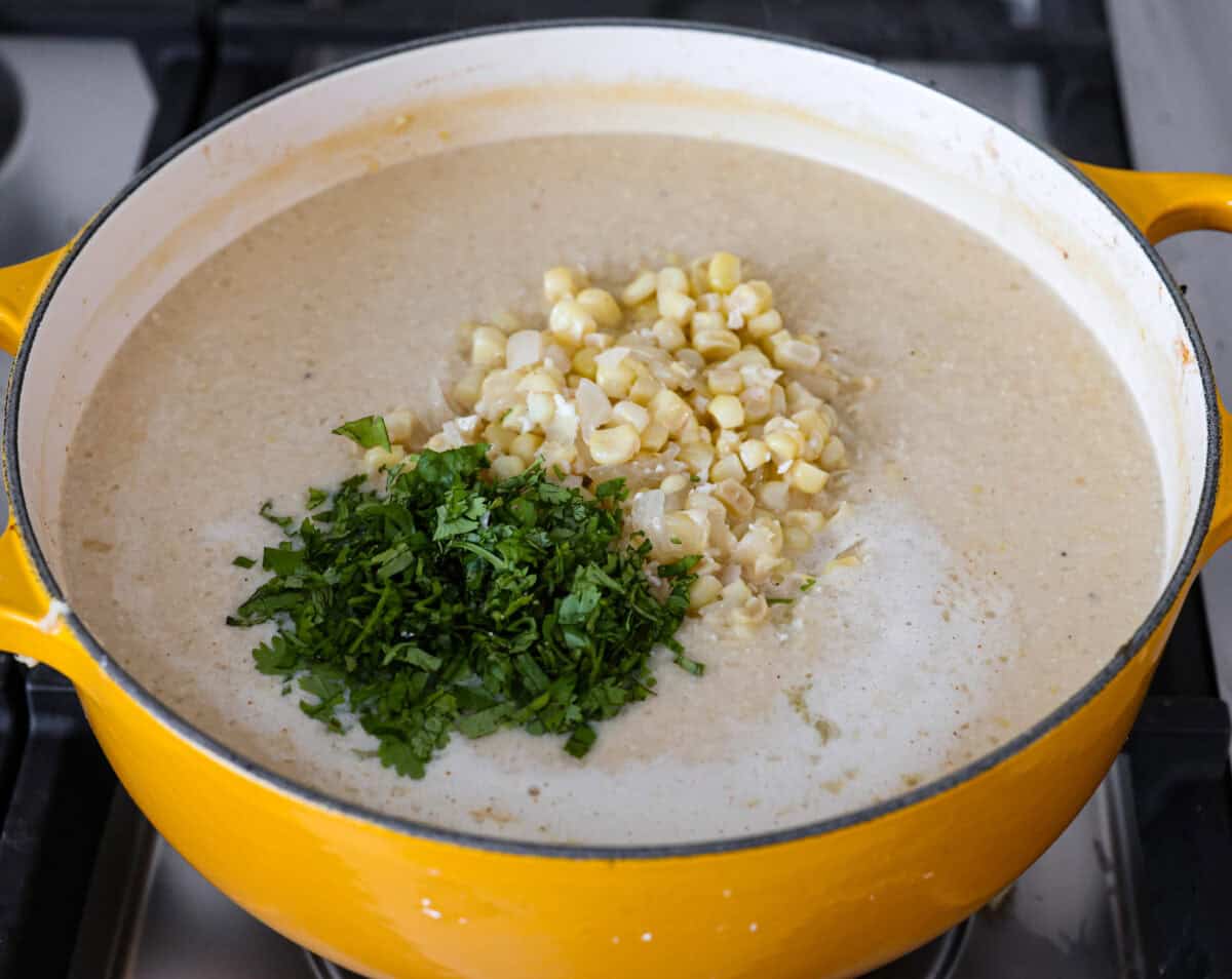 Angel shot of blended soup with cilantro and extra corn on top. 