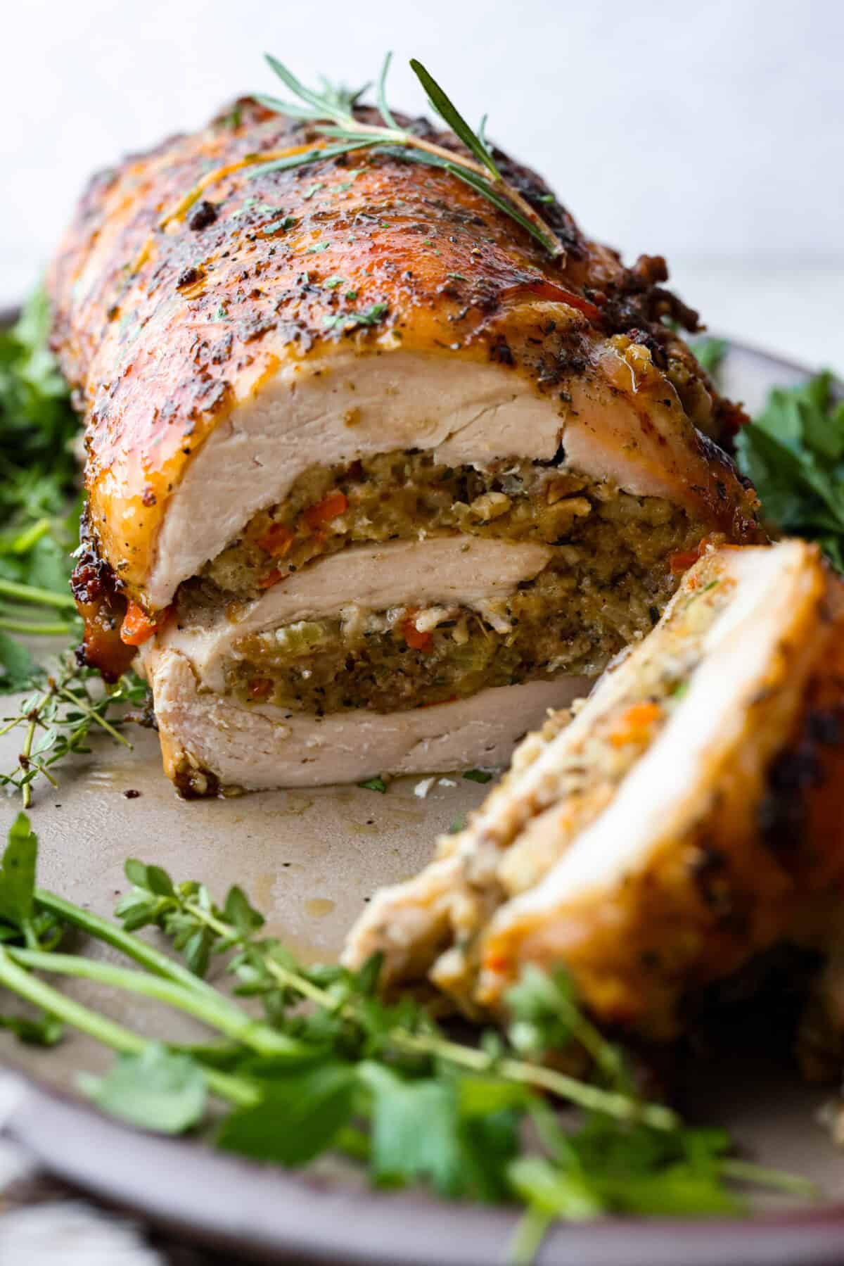 Close view of turkey roulade on a platter and sliced.